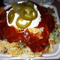 Loaded nachos with sour cream and jalapeños